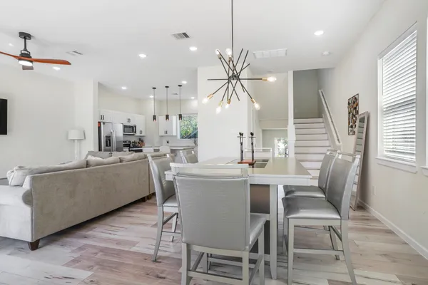 a dining room with furniture and wooden floor