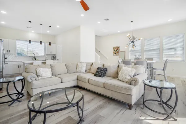 a living room with furniture or kitchen view and a chandelier