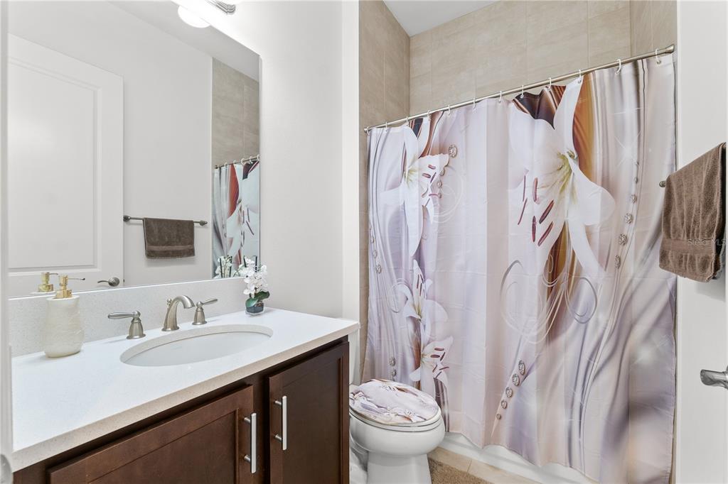 32558 Tree Of Life Avenue Wesley Chapel, FL 33543 - Photo 21 of 73 a bathroom with a granite countertop sink toilet and a mirror