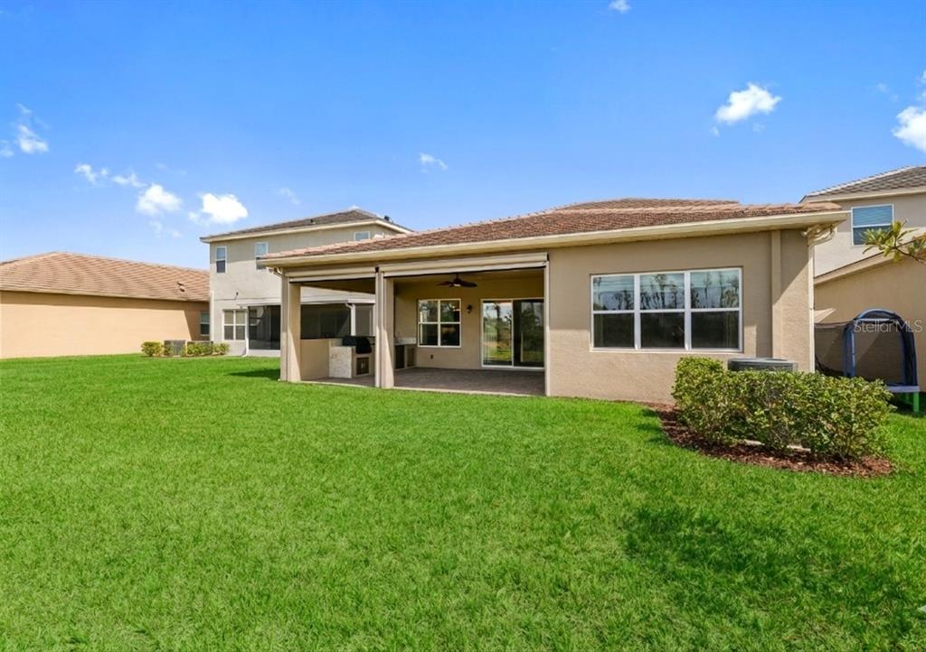 32558 Tree Of Life Avenue Wesley Chapel, FL 33543 - Photo 28 of 73 a view of an house with backyard porch and garden