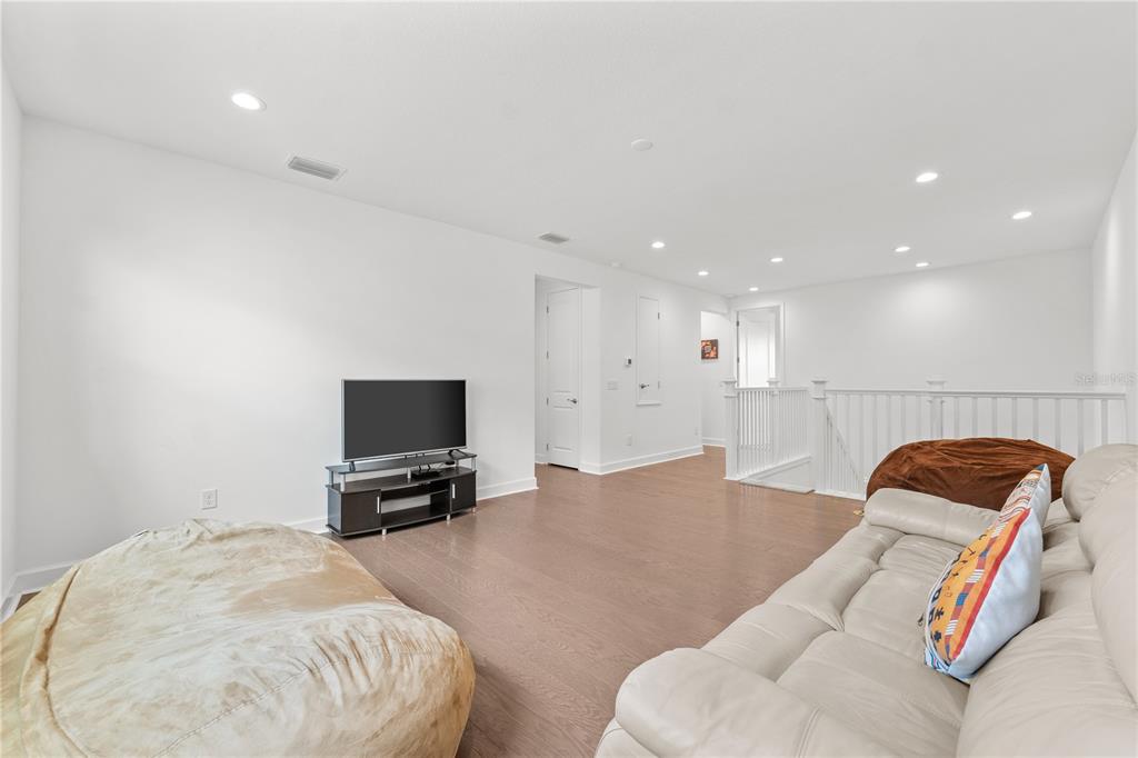 32558 Tree Of Life Avenue Wesley Chapel, FL 33543 - Photo 32 of 73 a living room with furniture and a flat screen tv