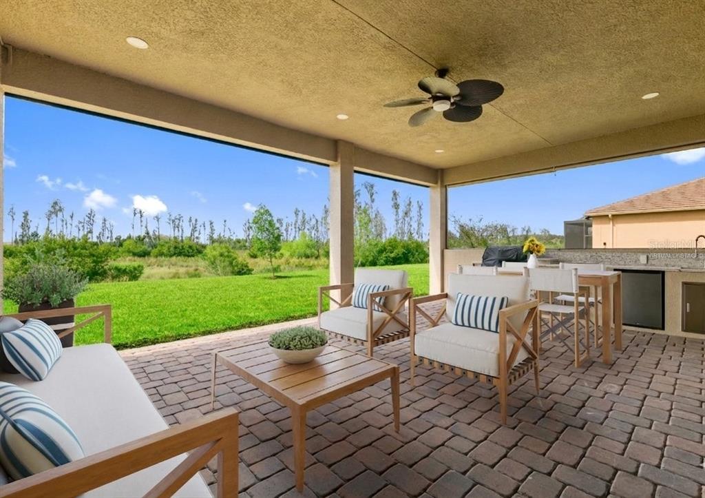 32558 Tree Of Life Avenue Wesley Chapel, FL 33543 - Photo 42 of 73 a view of a patio with a dining table and chairs with a yard