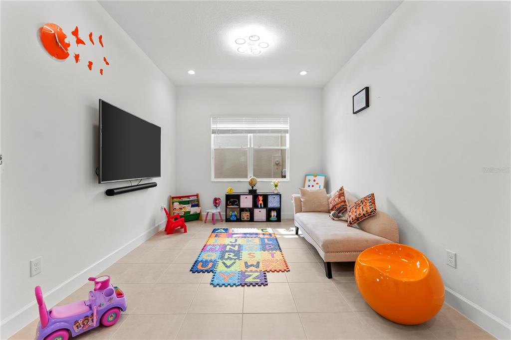 32558 Tree Of Life Avenue Wesley Chapel, FL 33543 - Photo 5 of 73 a living room with furniture and a flat screen tv