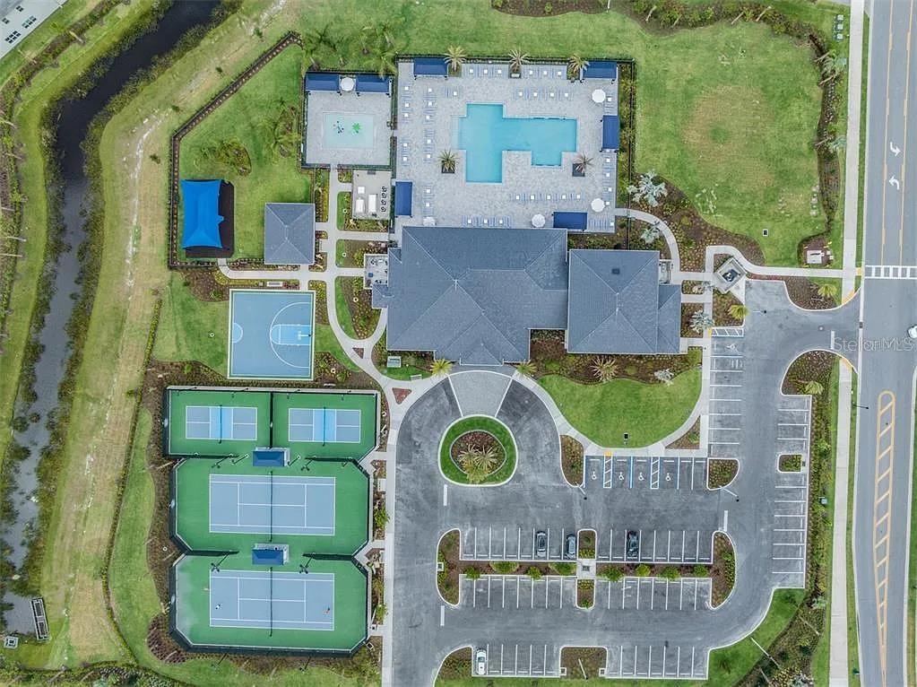 32558 Tree Of Life Avenue Wesley Chapel, FL 33543 - Photo 54 of 73 aerial view of residential house with outdoor space and parking