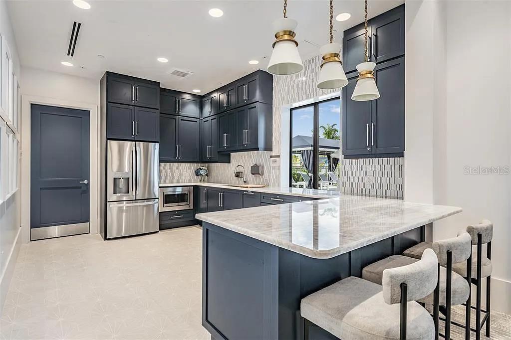 32558 Tree Of Life Avenue Wesley Chapel, FL 33543 - Photo 68 of 73 a kitchen with stainless steel appliances granite countertop a sink refrigerator and cabinets
