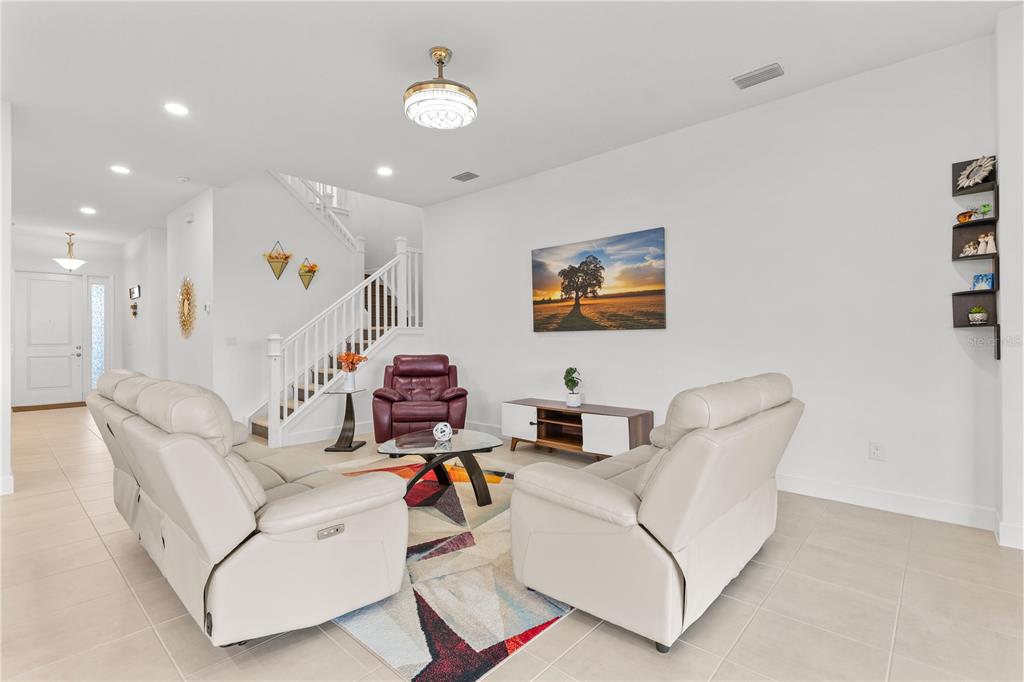 32558 Tree Of Life Avenue Wesley Chapel, FL 33543 - Photo 7 of 73 a living room with furniture and a flat screen tv