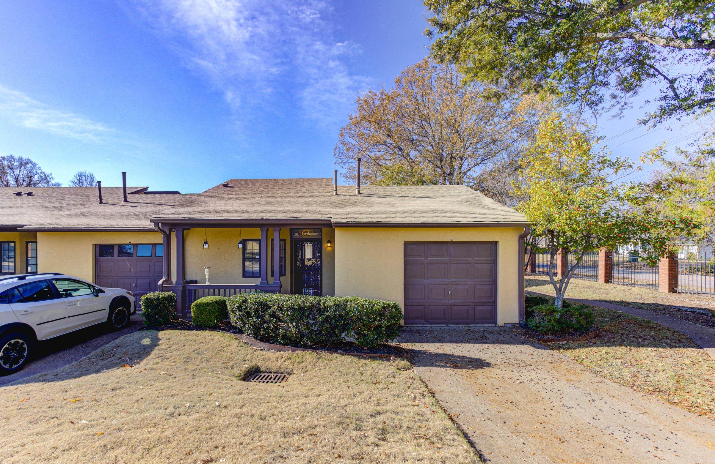 5013 Scheibler Road, Unit C1 Memphis, TN 38128 - Photo 2 of 36 Ranch-style home featuring covered porch, stucco siding, a shingled roof, and a garage