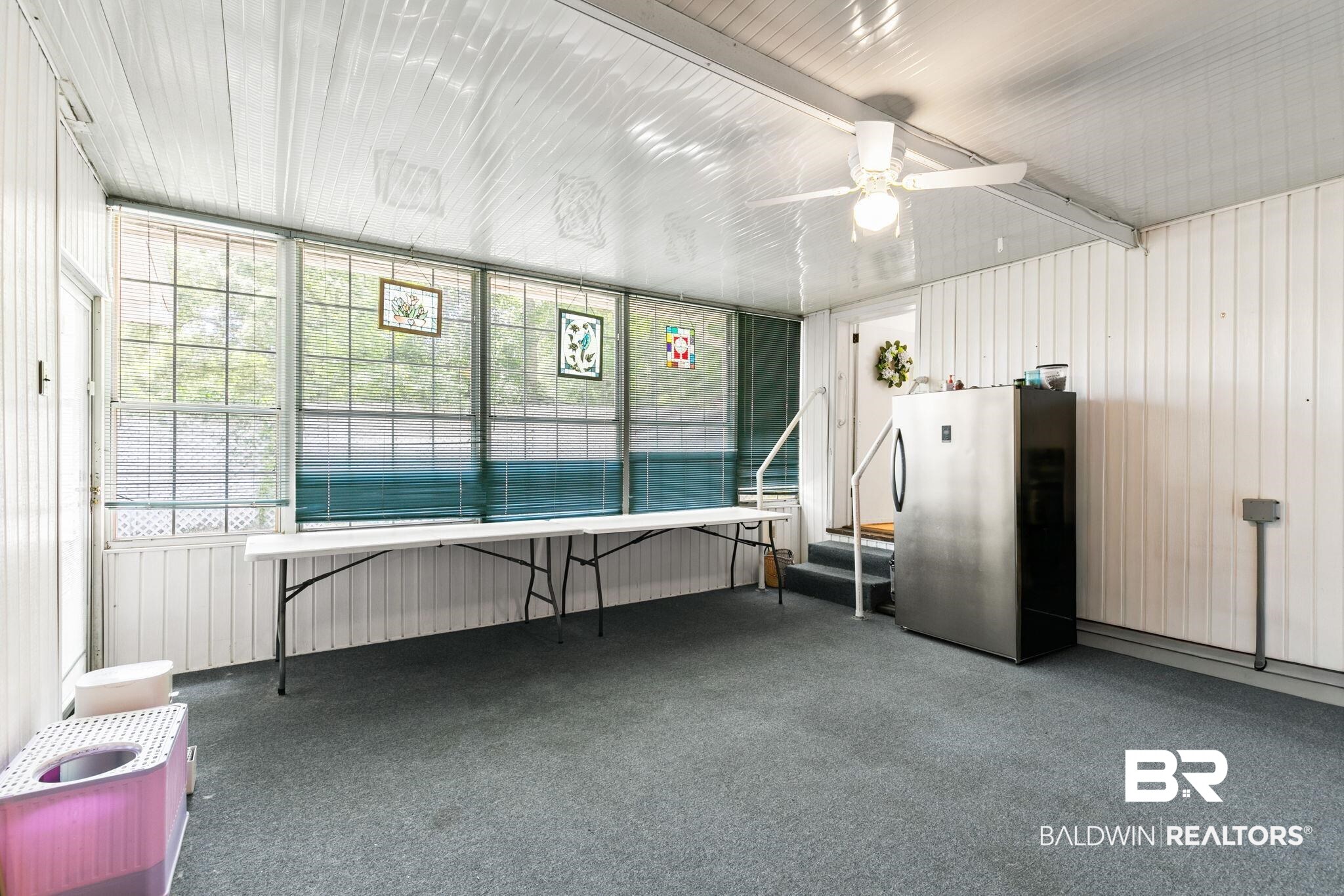 927 Cleveland Road Saraland, AL 36571 - Photo 38 of 80 Enclosed porch featuring large windows with blinds, white paneled walls, and a ceiling fan with integrated lighting