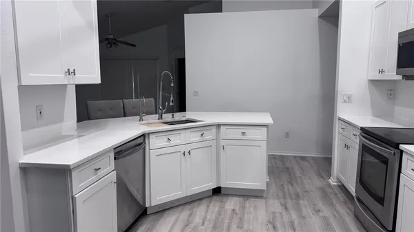a kitchen with a sink stove and cabinets