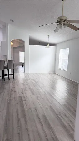a view of a room with wooden floor and a window