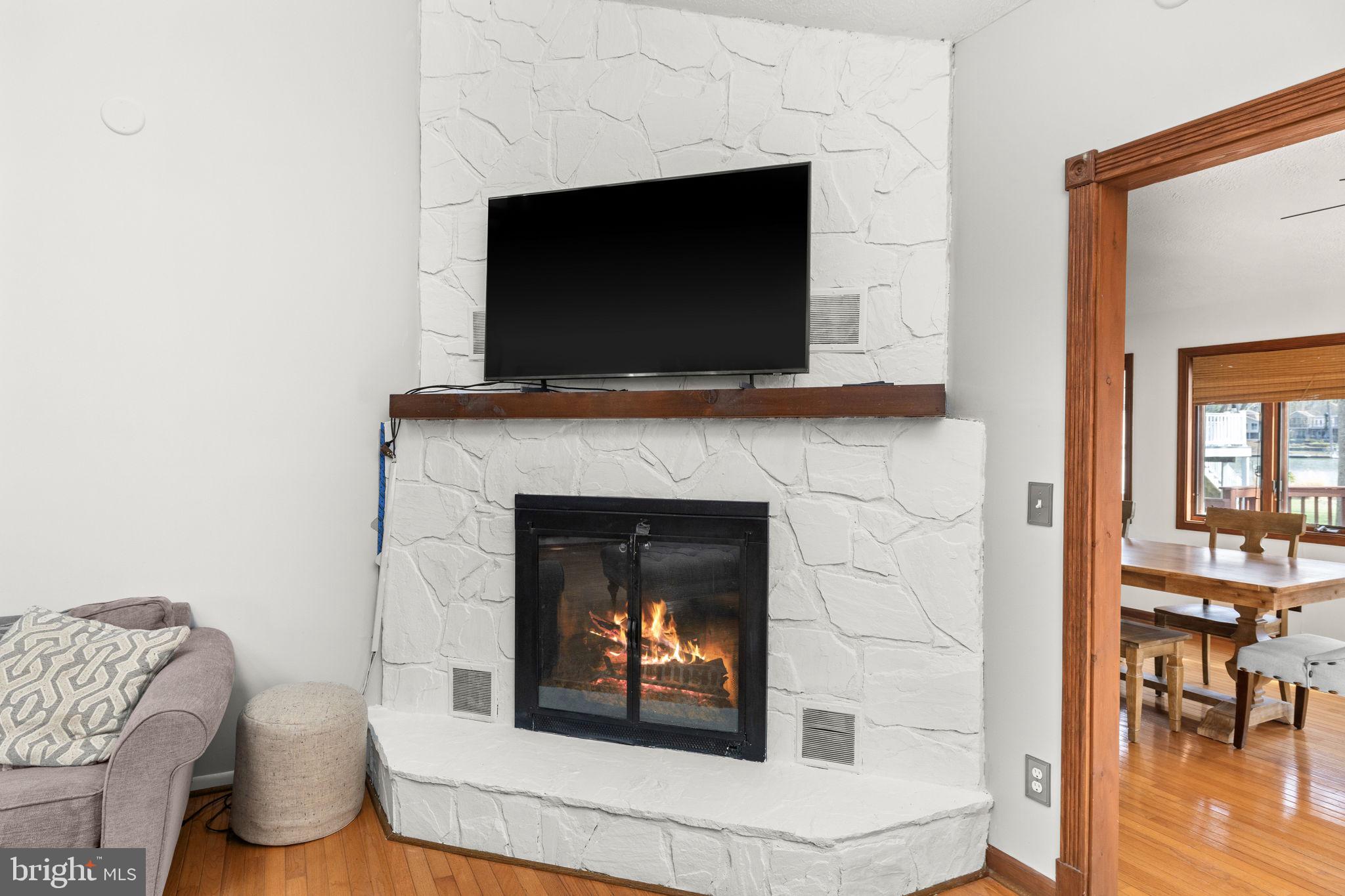 128 Harrison Circle Locust Grove, VA 22508 - Photo 12 of 65 a living room with a fireplace and a flat screen tv