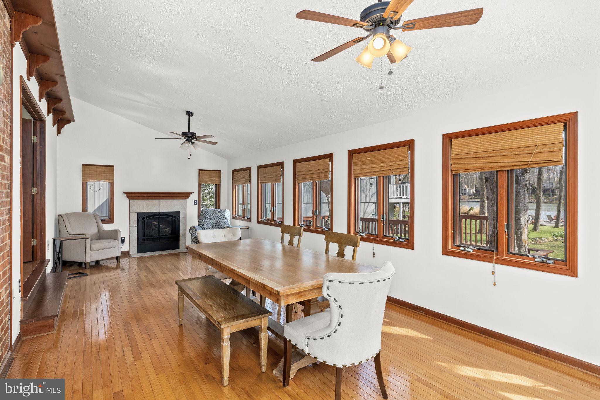 128 Harrison Circle Locust Grove, VA 22508 - Photo 15 of 65 a dining room with wooden floor a chandelier a glass table and chairs
