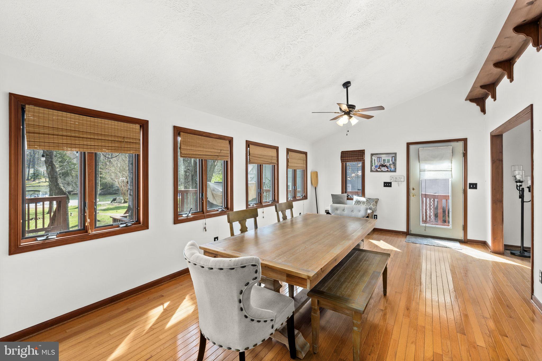 128 Harrison Circle Locust Grove, VA 22508 - Photo 16 of 65 a dining room with wooden floor and chandelier