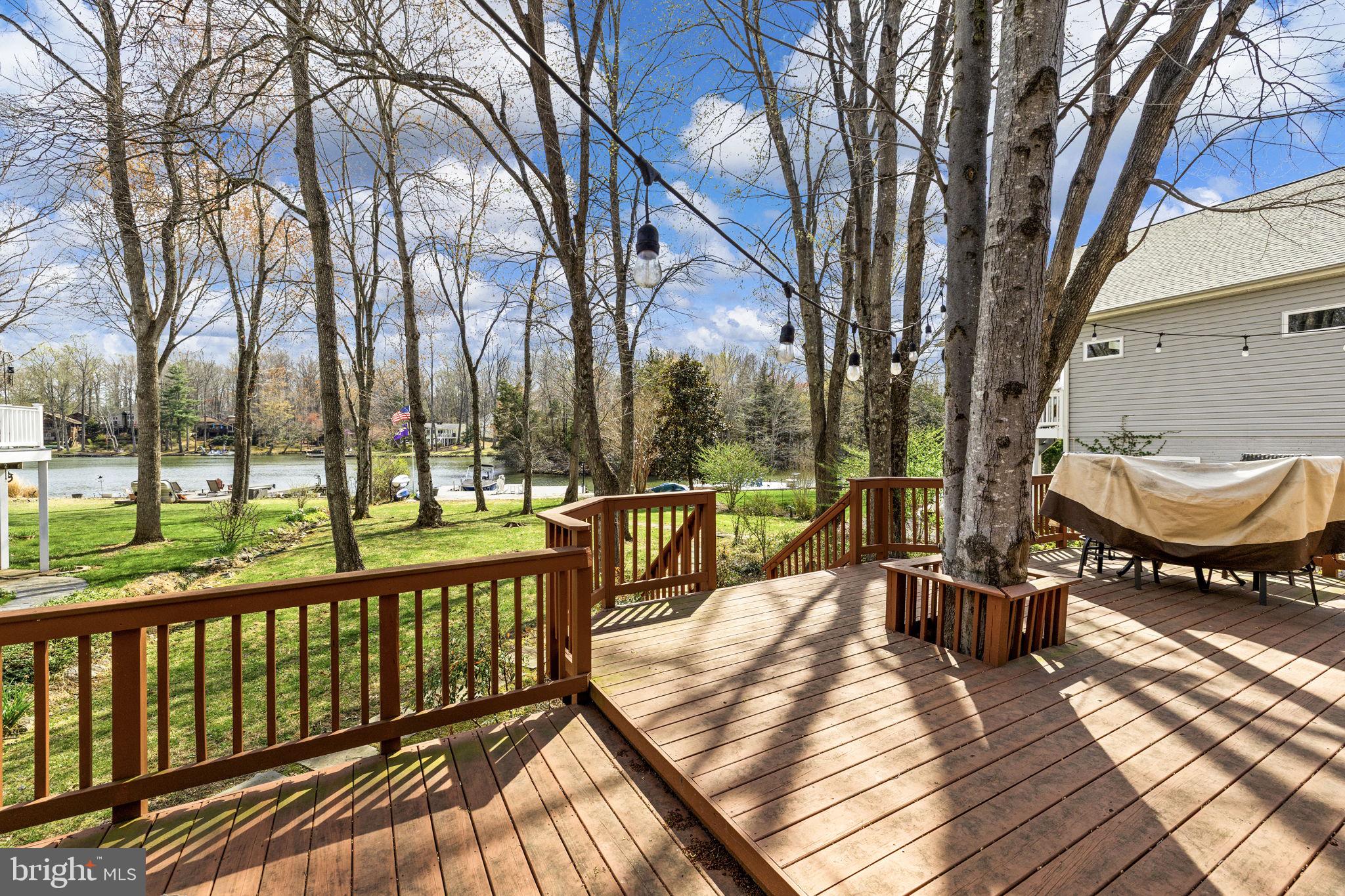 128 Harrison Circle Locust Grove, VA 22508 - Photo 39 of 65 a view of a balcony with chairs and wooden floor