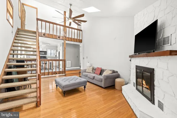 a kitchen with a stove a sink dishwasher a dining table and chairs with wooden floor