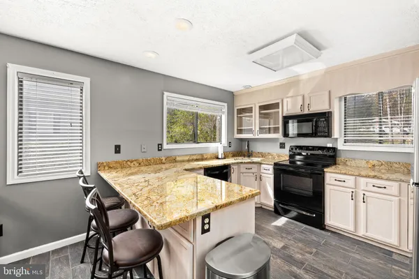 a kitchen with stainless steel appliances granite countertop a stove and a sink