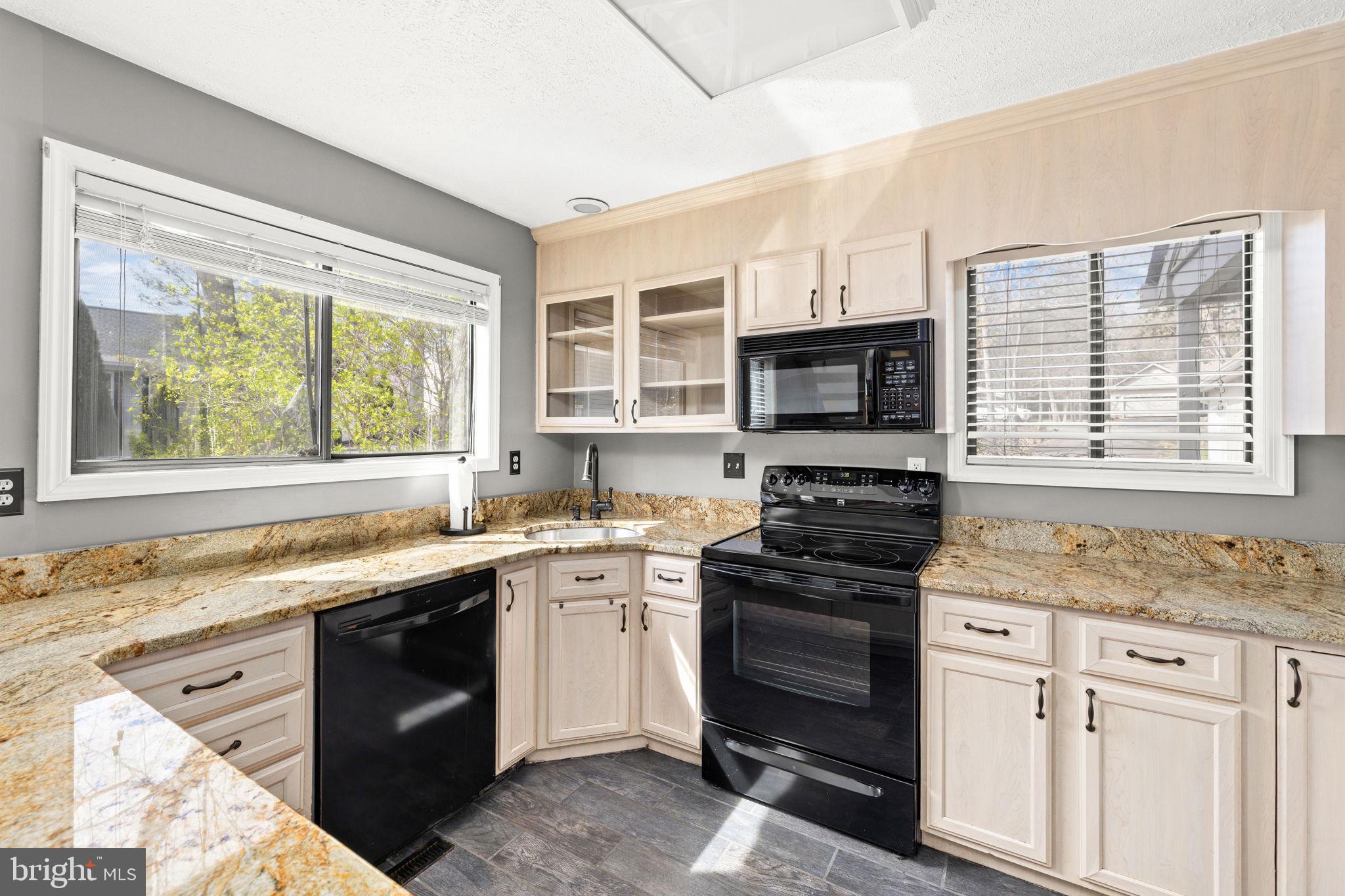 128 Harrison Circle Locust Grove, VA 22508 - Photo 9 of 65 a kitchen with stainless steel appliances granite countertop a stove and a sink