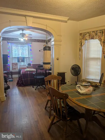 a view of a dining room with furniture and wooden floor