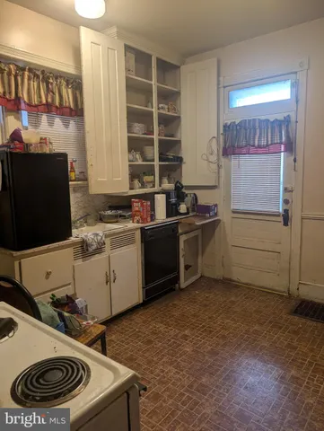 a kitchen with a stove and a refrigerator