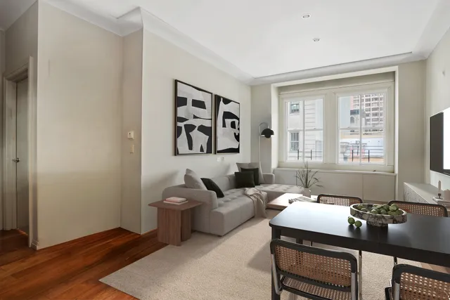 a living room with furniture a flat screen tv and a large window
