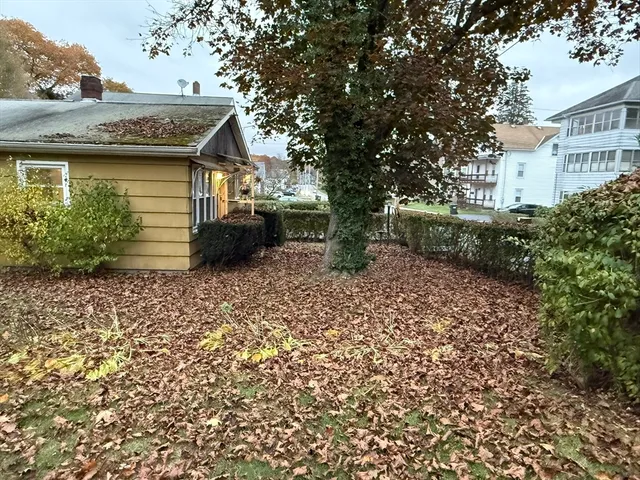 a view of a house with a yard and sitting area