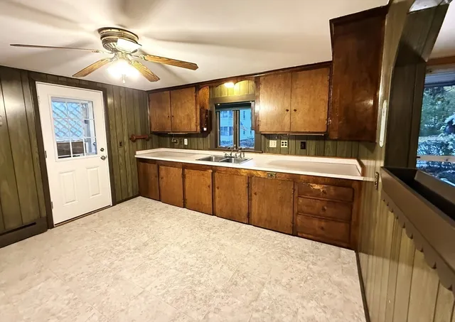a kitchen with stainless steel appliances a sink and cabinets