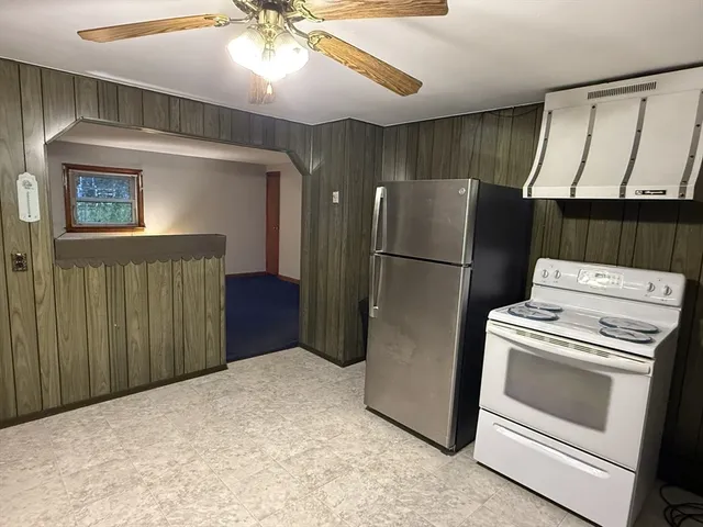 a kitchen with a refrigerator and cabinets