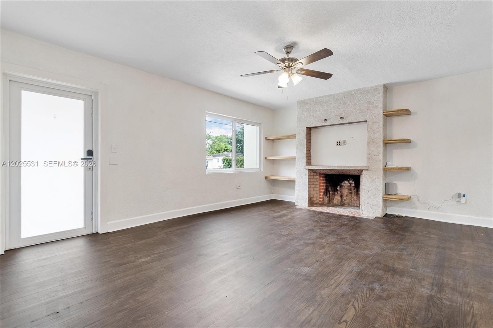 3951 Southwest 2nd Terrace, Unit 3951 Miami, FL 33134 - Photo 3 of 21 an empty room with windows fireplace and sink
