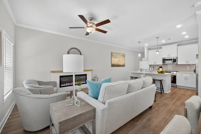 a kitchen with a table chairs refrigerator and microwave