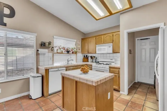 a kitchen with a stove a refrigerator and cabinets