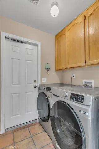 a utility room with sink dryer and washer