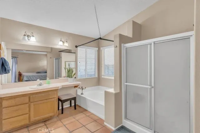 a bathroom with a tub sink and mirror
