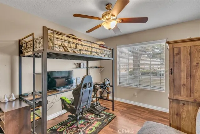 a view of a livingroom with furniture and a ceiling fan
