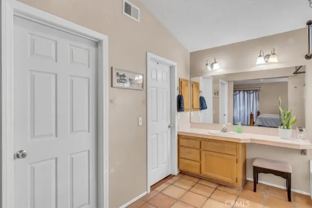 a bathroom with a sink vanity and a mirror
