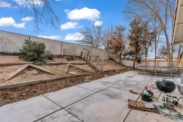 a view of a backyard with chair and tables