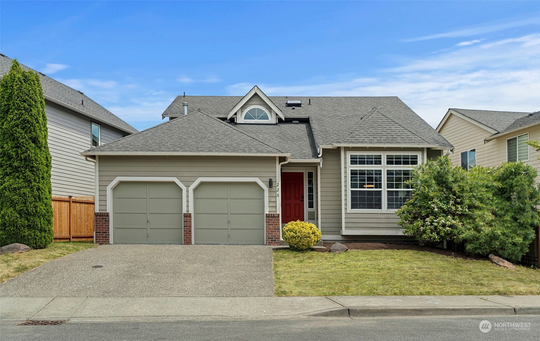 226 Whitman Place Northeast Renton, WA 98059 - Photo 1 of 26 a front view of a house with a yard and garage