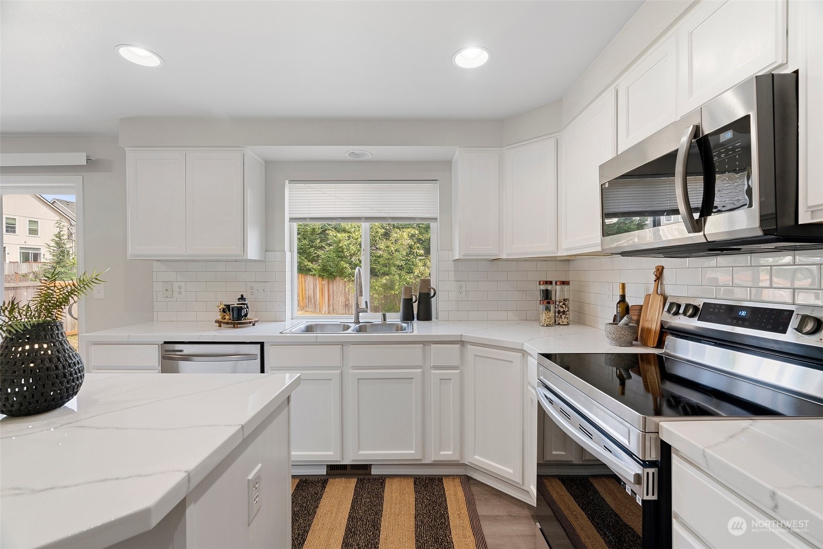 226 Whitman Place Northeast Renton, WA 98059 - Photo 11 of 26 a kitchen with a sink stove and microwave