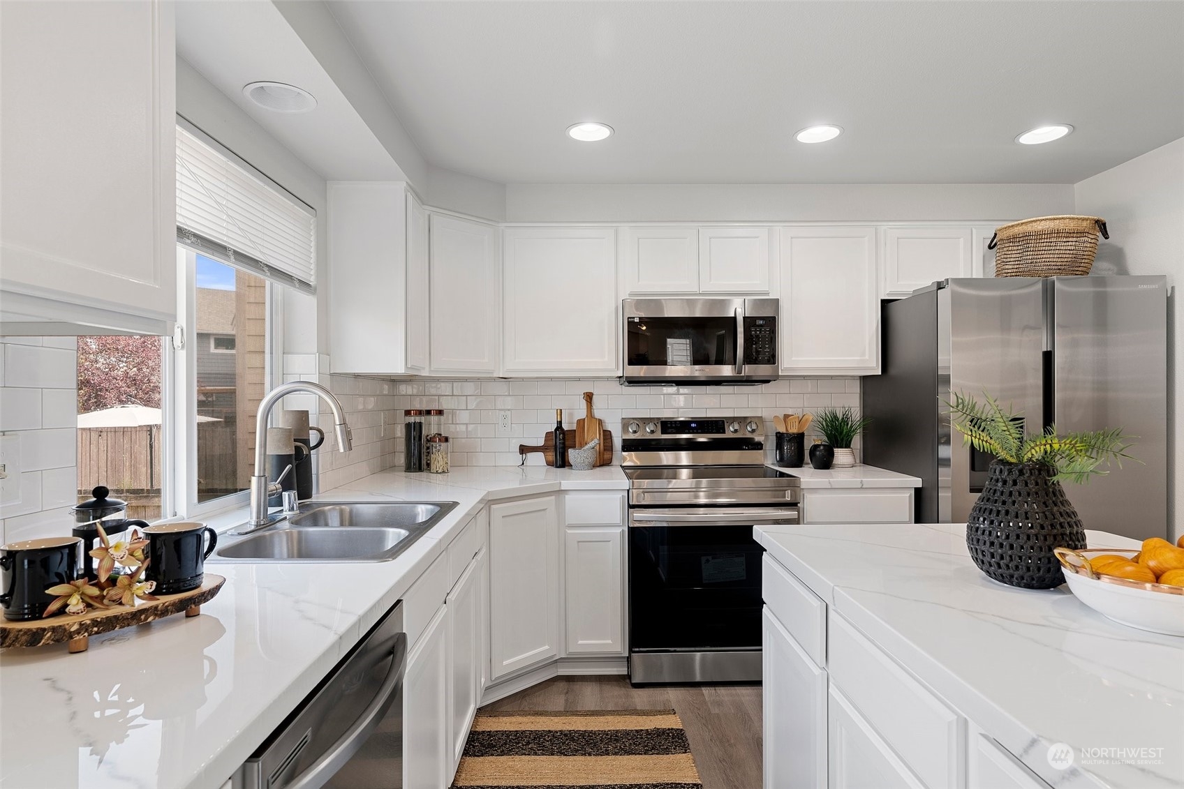 226 Whitman Place Northeast Renton, WA 98059 - Photo 12 of 26 a kitchen with a sink a counter top space appliances and cabinets
