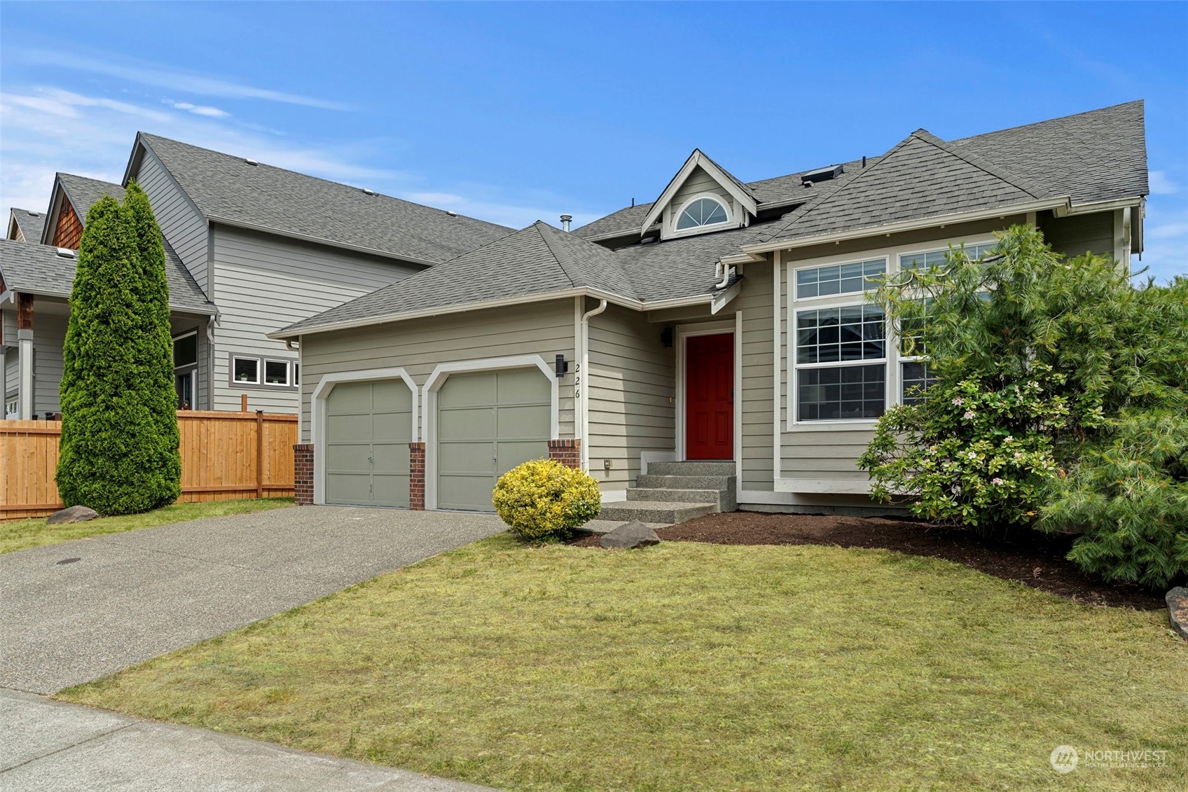 226 Whitman Place Northeast Renton, WA 98059 - Photo 3 of 26 a front view of a house with garden