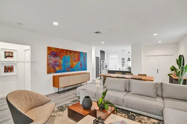 a living room with furniture a rug and a large window