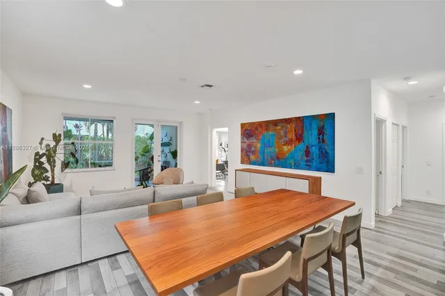 a dining room with furniture a potted plant and a chandelier