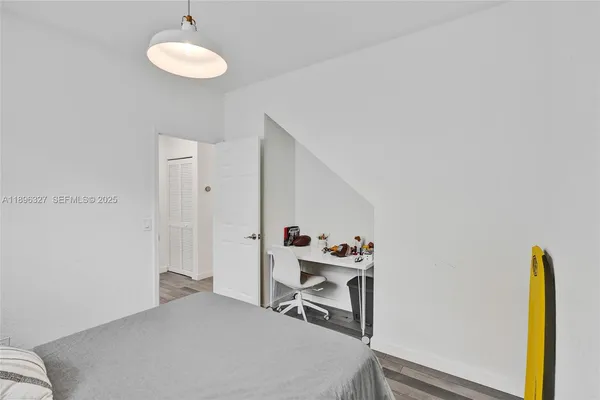 a room with wooden floor and furniture