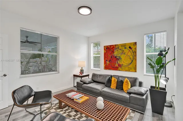 an aerial view of an houses with greenery space and a garden