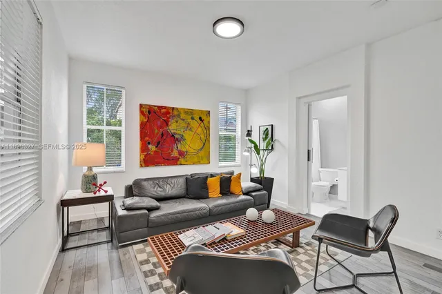 an aerial view of house with yard and lake view in back