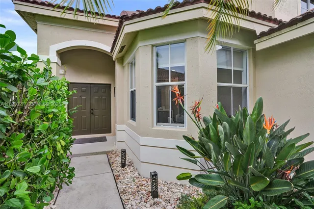 a front view of a house with a garden