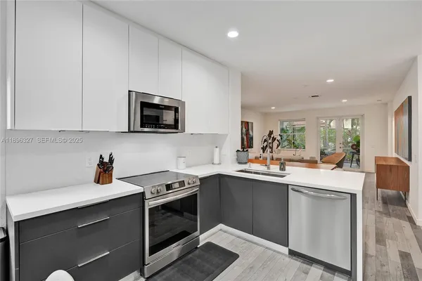 a kitchen with stainless steel appliances kitchen island granite countertop a sink and cabinets