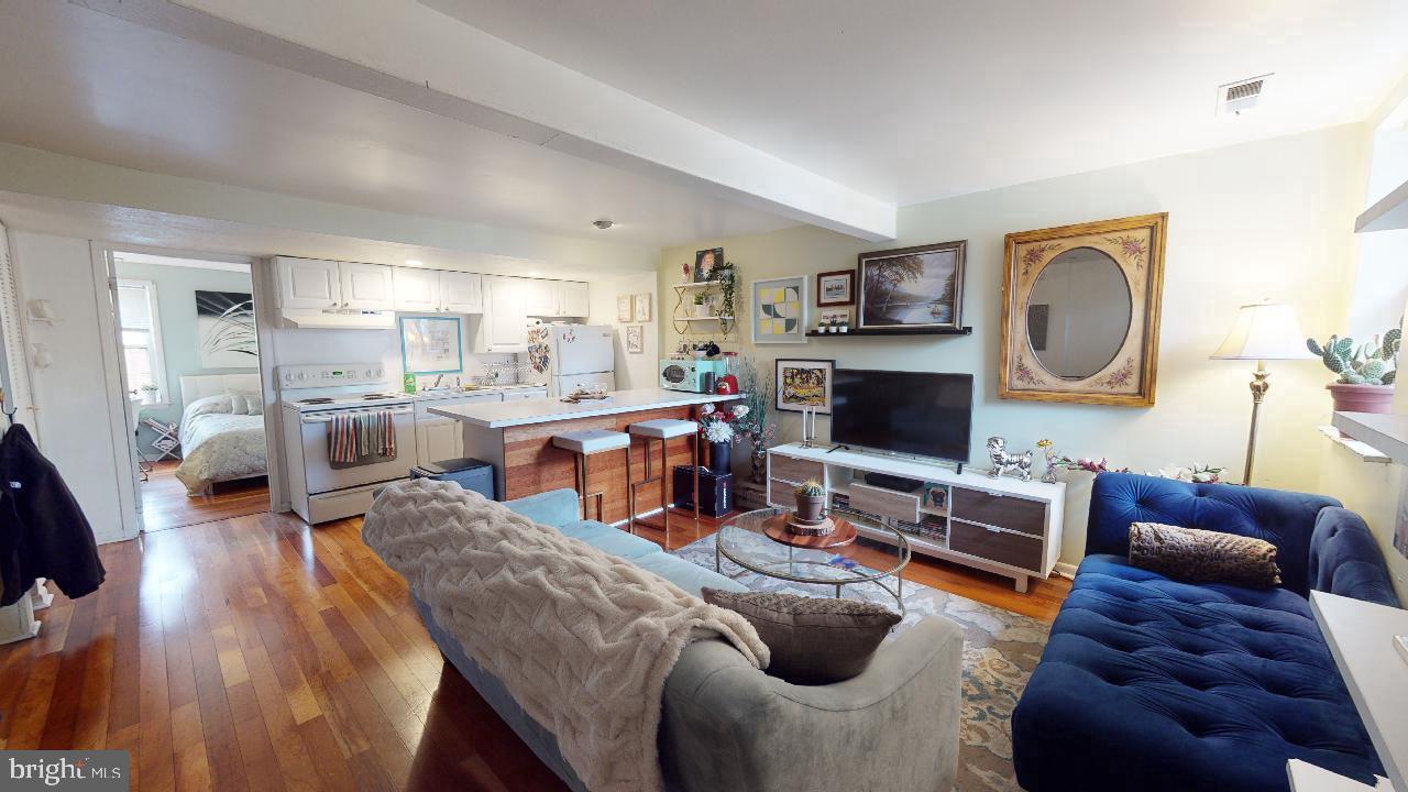 1018 Pine Street, Unit 3F Philadelphia, PA 19107 - Photo 1 of 10 a living room with furniture and a flat screen tv