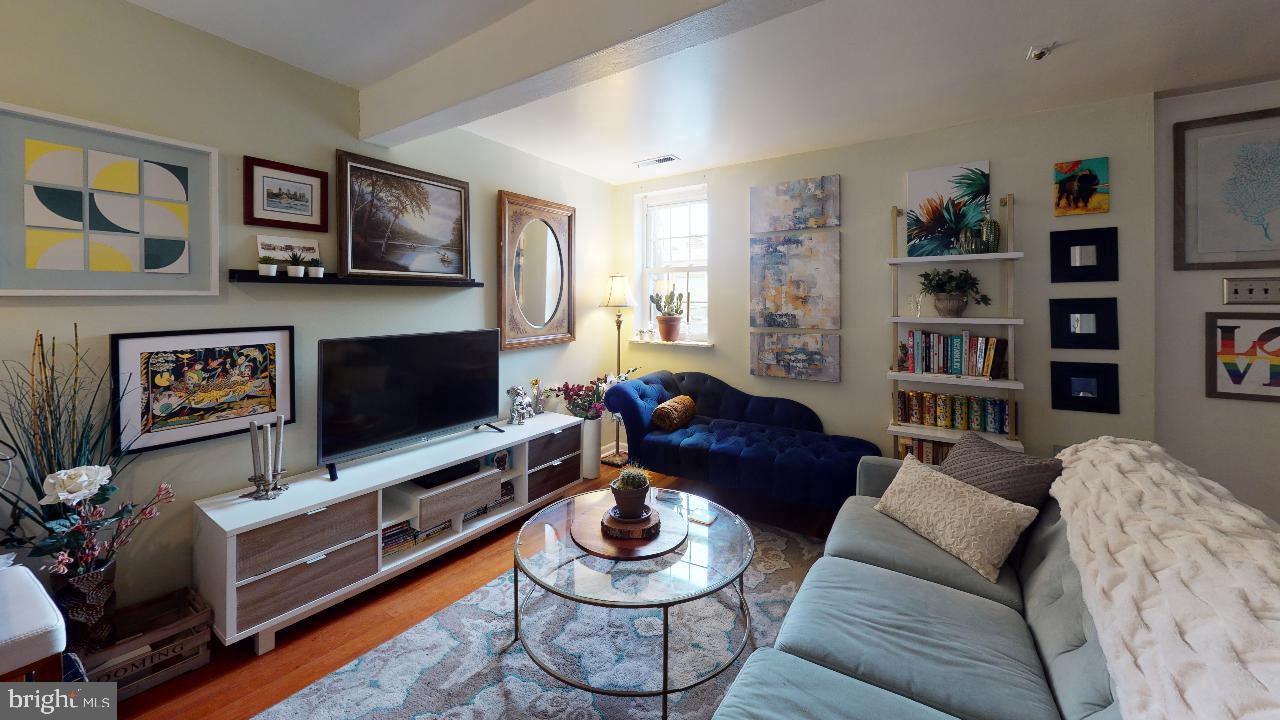 1018 Pine Street, Unit 3F Philadelphia, PA 19107 - Photo 3 of 10 a living room with furniture and a flat screen tv