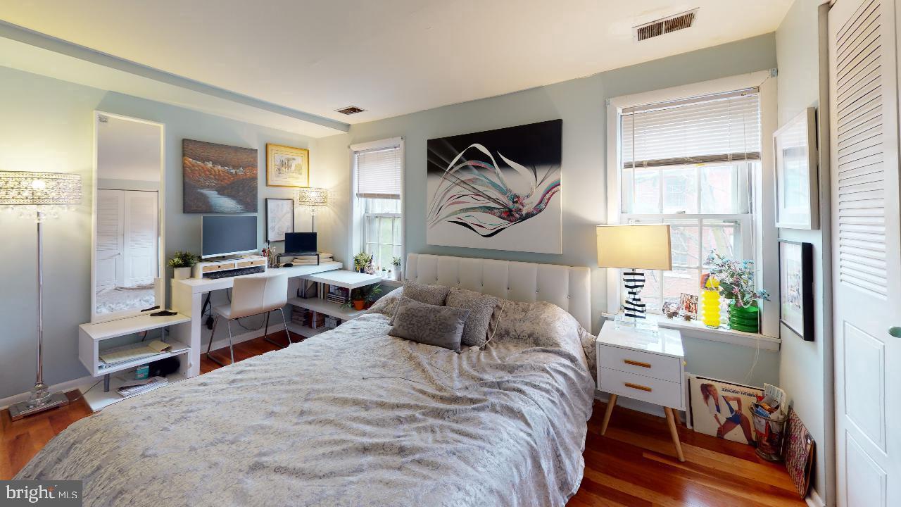 1018 Pine Street, Unit 3F Philadelphia, PA 19107 - Photo 6 of 10 a bedroom with a bed and wooden floor