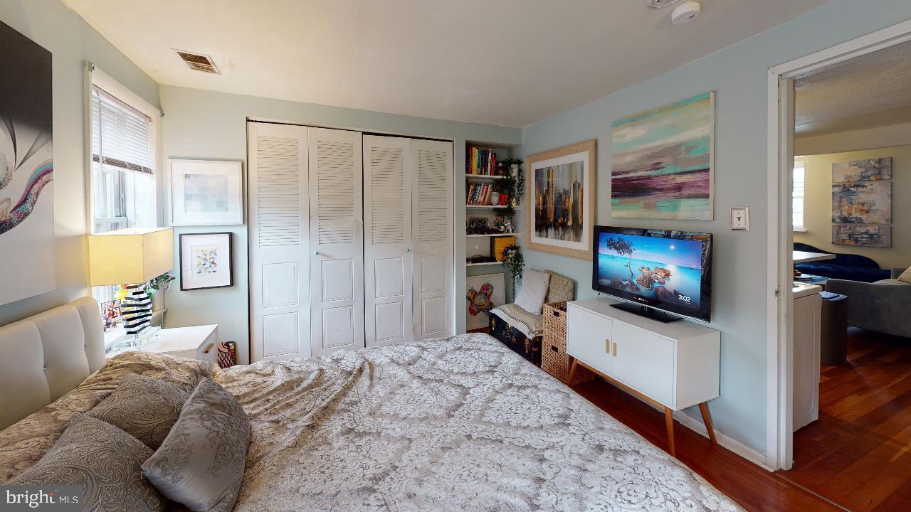 1018 Pine Street, Unit 3F Philadelphia, PA 19107 - Photo 7 of 10 a bedroom with a bed and a flat screen television
